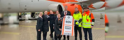 easyJet cabin crew and Southampton Airport ground staff celebrating the launch of the new Southampton to Amsterdam service on the runway.