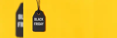 A black gift label with the words 'BLACK FRIDAY' written on it on a yellow background.