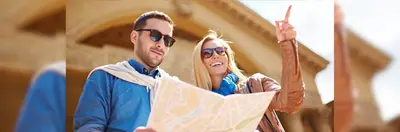 A young couple on a city break looking at a map.