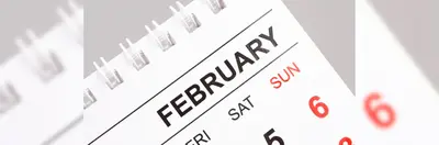 A spiral calendar open on the February page.
