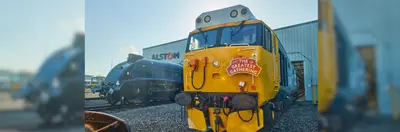 A train with 'The Greatest Gathering' sign on it outside Alstom's Works in Derby