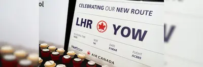 A large boarding pass celebrating the new route 