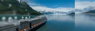 Holland America's Westerdam vessel sailing towards ice capped mountains