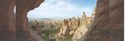 The view of Cappadocia's 'Fairy Chimneys', or hoodoo rock formations, from inside a cave.