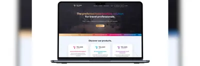 An Apple laptop open on the home page of Teldar Travel's website.