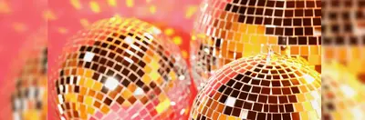 Three disco balls against a pink backdrop