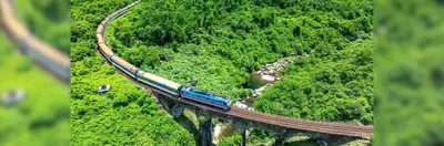 The Blue Jasmine train journeying across a viaduct in Thailand.