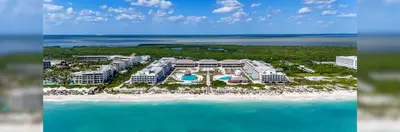 Ocean Allure Costa Mujeres in Mexico, a large white resort with the blue ocean in front