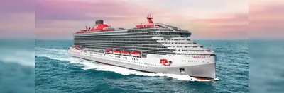 Virgin Voyages' Resilient Lady ship sailing against a pink sky.