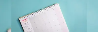 A spiral-bound monthly 2026 calendar, open on the January page.