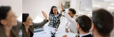 four happy agents high-fiving