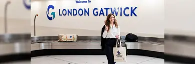 lady carrying a Singapore Airlines bag at London Gatwick baggage claim