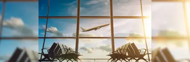 An airplane ascending, seen from a terminal waiting area