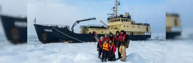 Secret Atlas private charter vessel with a family stood on the ice