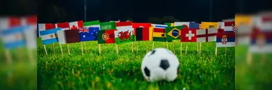 A football in front of a field of flags