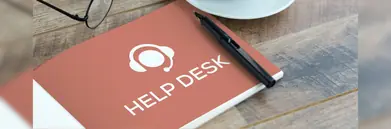 A notepad with 'Help Desk' written on it