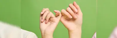 Two people making a pinky promise