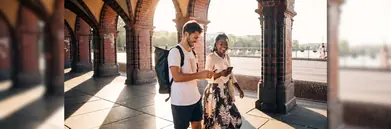 A couple walking down a shaded street