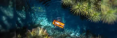 A woman laying on a float in a river