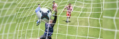 A footballer scoring a goal
