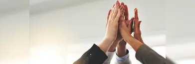 A group of five high-fiving