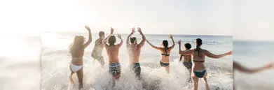People playing in the sea at a beach