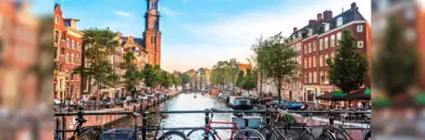 Amsterdam canal with bikes leaning against railing