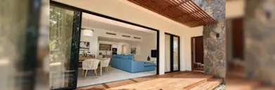 Sunlife apartment with sofa, dining space, and outdoor space with pool