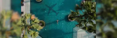 Man in pool with plane shadow