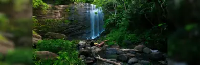 Mt Carmel waterfall with woman lying on rocks in front of it
