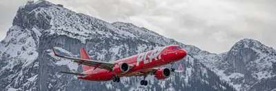 PLAY plane flying in snowcapped mountains