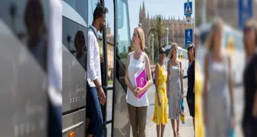 Just You Travel tour guide welcoming guests off a coach.