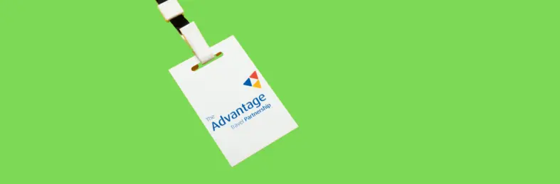 A lanyard with the Advantage Travel Partnership logo on a green background.