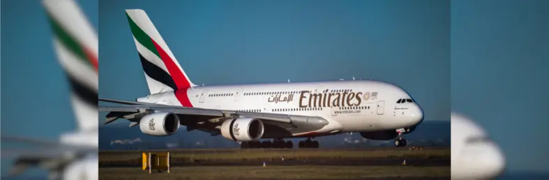 An Emirates Boeing plane on the runway after landing.