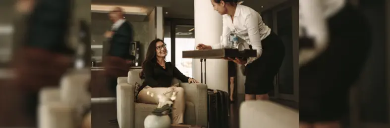 A passenger being served a drink at an airport lounge.