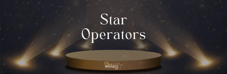 The Travel Bulletin Star Awards logo with a black and sparkly gold background.
