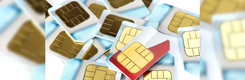 A number of SIM cards scattered across a table.