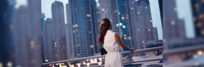 A lady overlooking the Dubai skyline.
