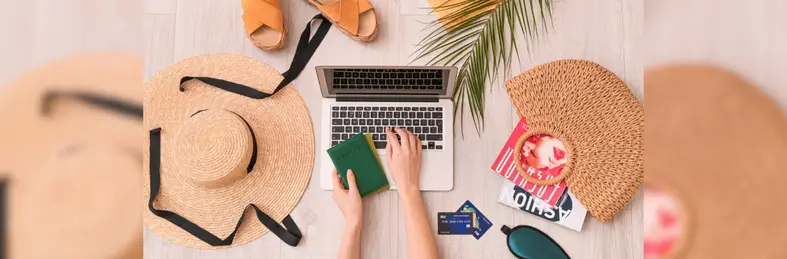 Someone booking a holiday on an Apple MacBook.