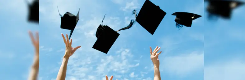 Graduates throwing their caps in the air.