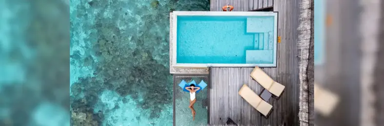 Image of a woman sunbathing over the ocean