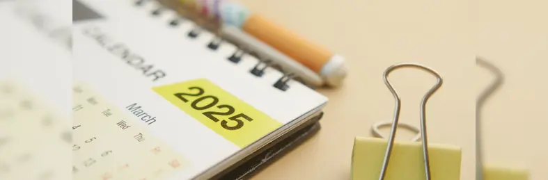 A spiral calendar open on March 2025.