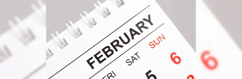 A spiral calendar open on the February page.