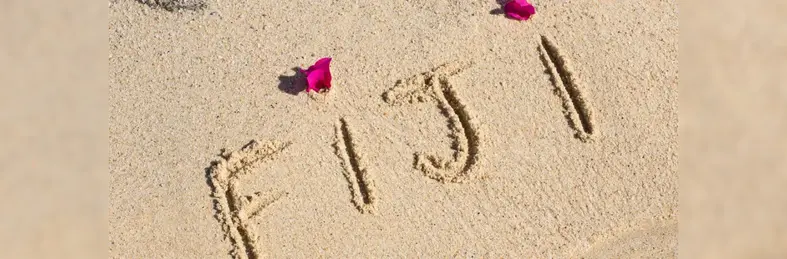The word 'FIJI' written in the sand. 