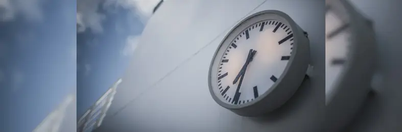 A clock attached to a bulkhead of a cruise ship.