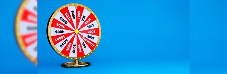 A spinning prize wheel with red and white segments displaying different prize cash amounts.