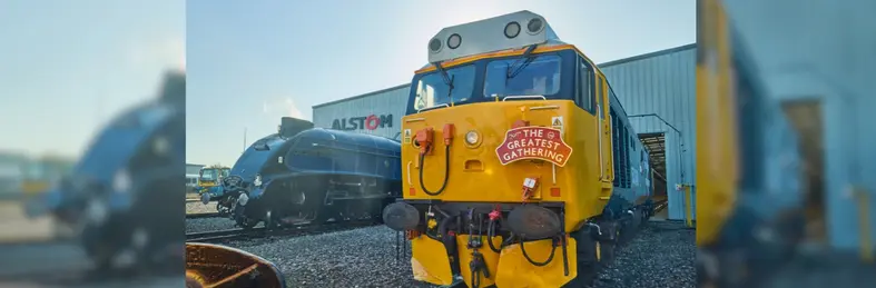 A train with 'The Greatest Gathering' sign on it outside Alstom's Works in Derby