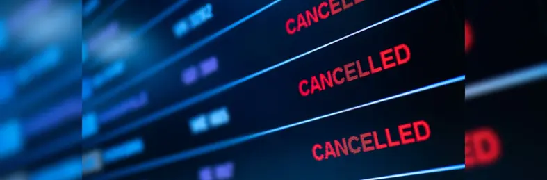 A departure board at an airline displaying three Cancelled flights.