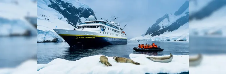 Image of the National Geographic Delfina vessel in the ice with seals 