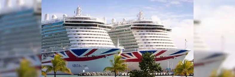 P&O Cruises' Iona and Arvia ships docked adjacent to each other in the Caribbean.